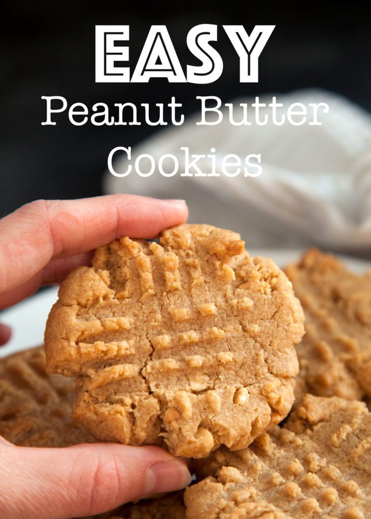 Pinterest pin of a peanut butter cookie being held in front of a plate of peanut butter cookies.