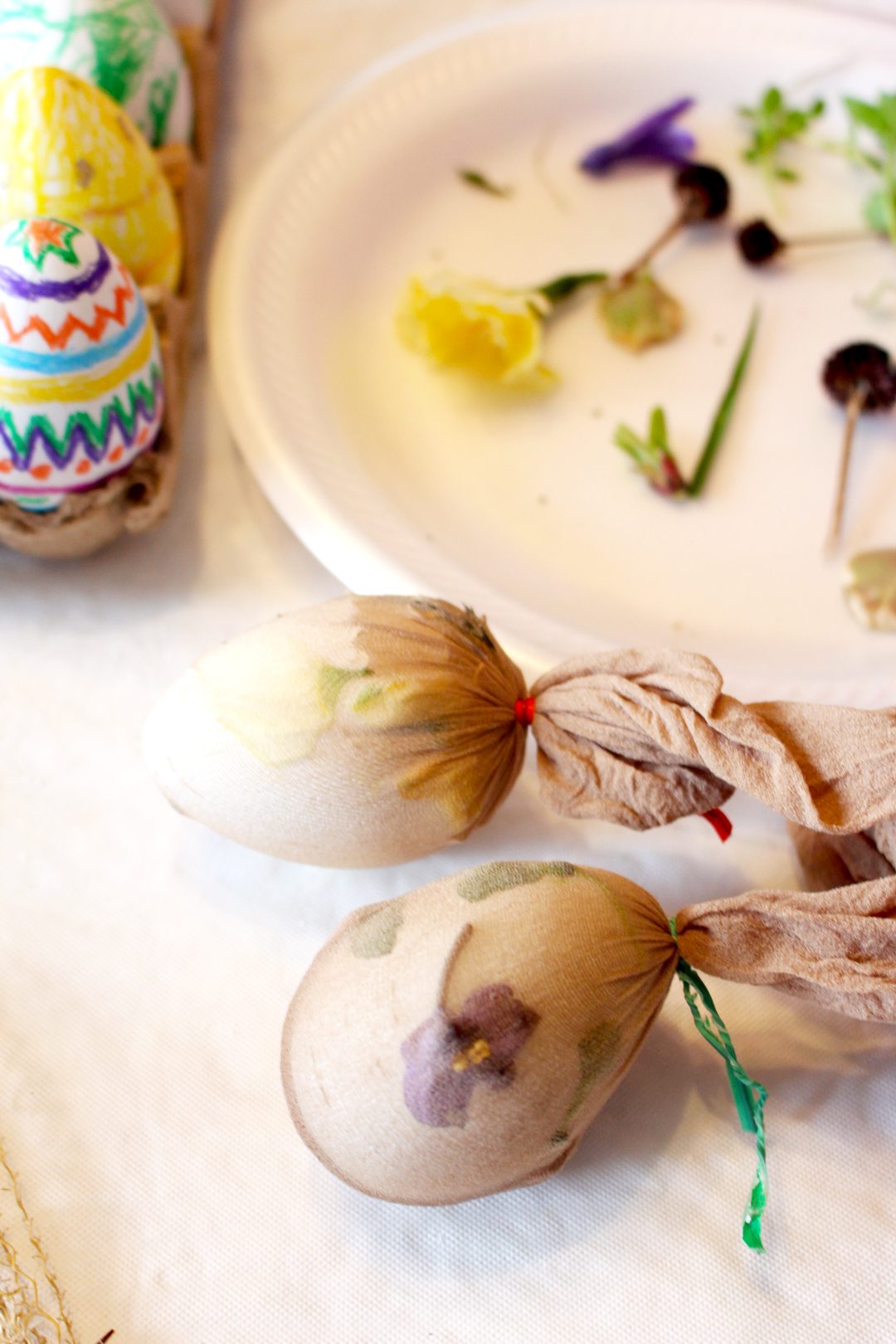 Panty hose wrapped around easter eggs and flowers, ready to dye.