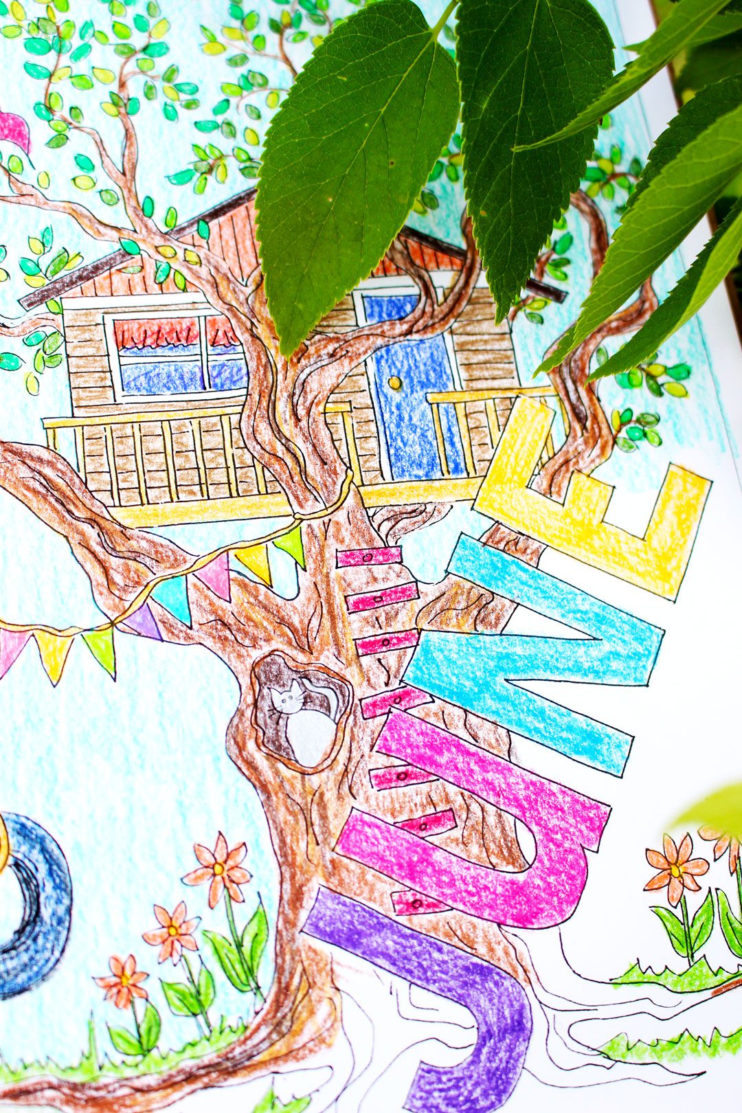 A month of June coloring page with a tree house in a large tree.