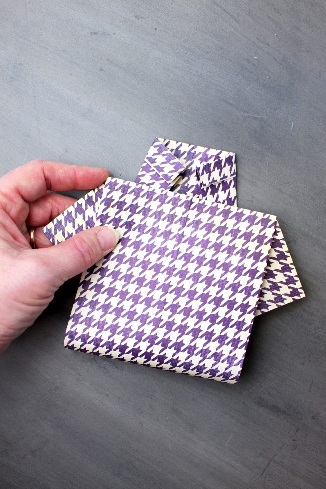 A purple houndstooth pattern folded origami shirt.