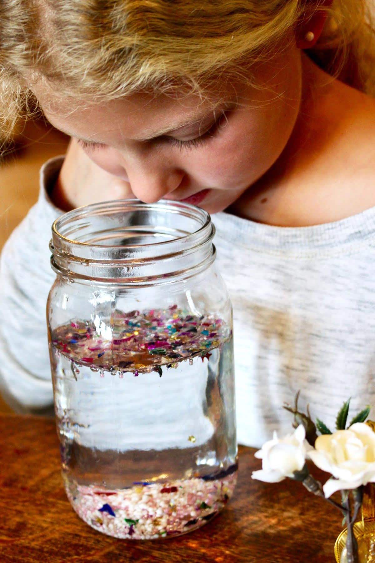 Child looking at glitter in the snow globe.