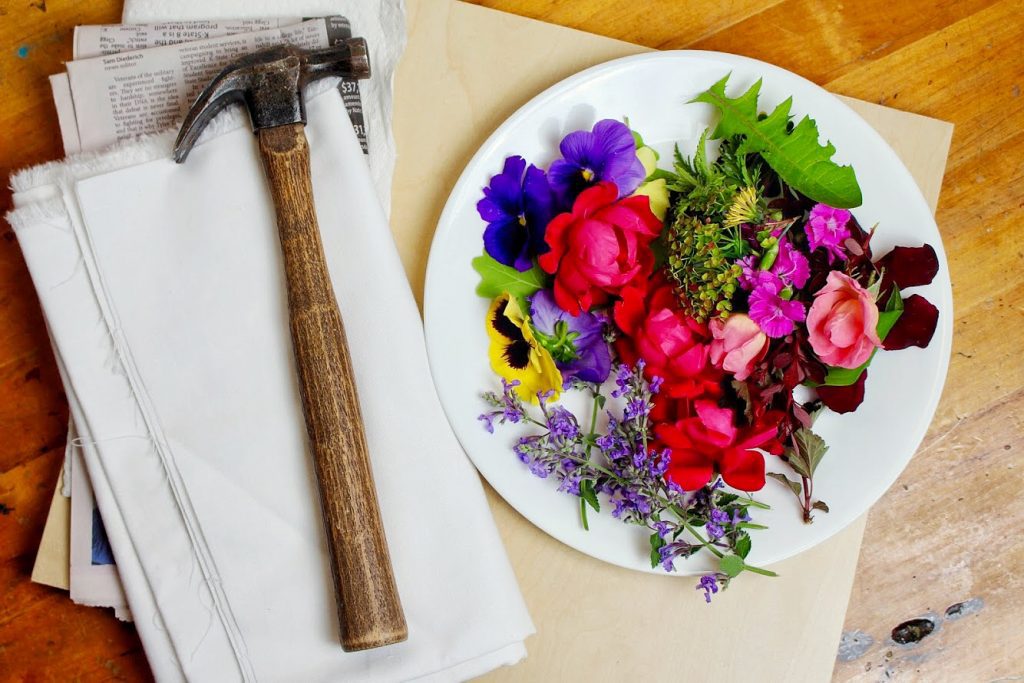 A hammer, plate of flowers, and fabric.