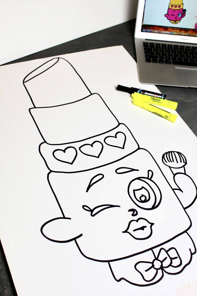 The outline of a lipstick cartoon character drawn for custom pin the tail game for kids.