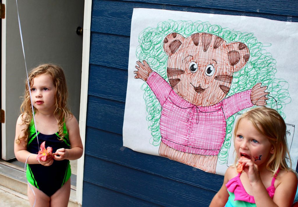Children at a party ready to play a custom pin the nose on a bear game.