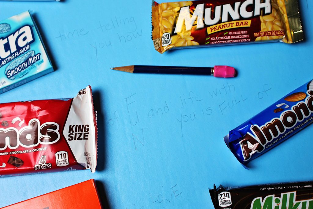 Pencil drawn letters of a card with candy bars around it.
