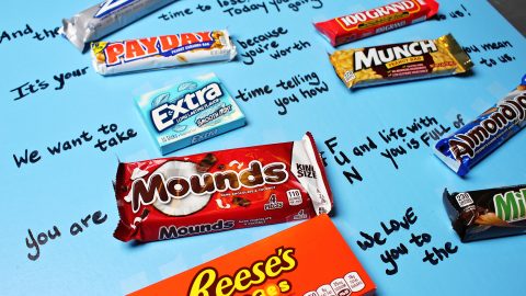 Assorted candy bars laid out on a poster board as a Valentines card.