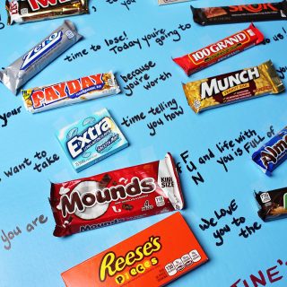 Assorted candy bars laid out on a poster board as a Valentines card.