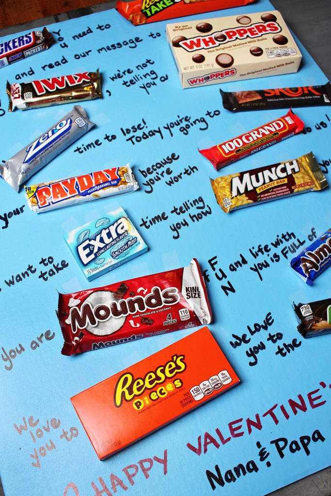 Assorted candy bars laid out on a poster board as a Valentines card.
