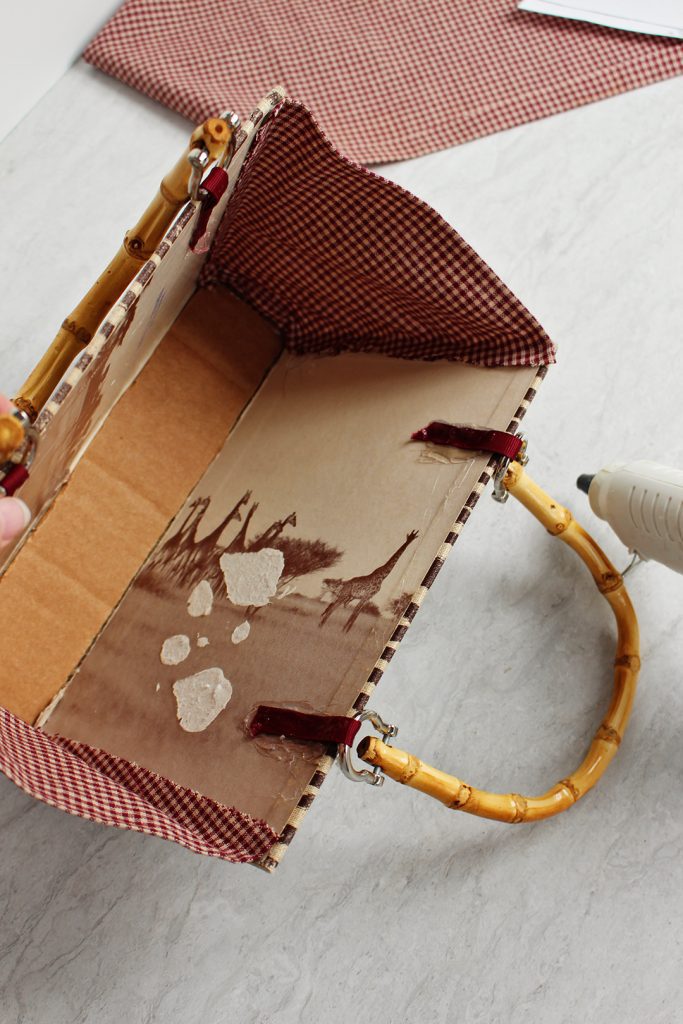 Line the inside of the purse with fabric and hot glue.