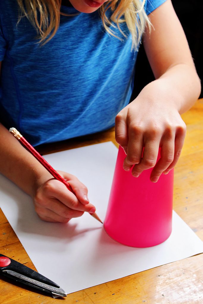 Use a cup to draw two of the same sized circles on a piece of paper. 