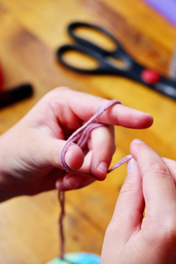 As the string re-twists, allow your hands to move back together a bit so that the string can twist up more.