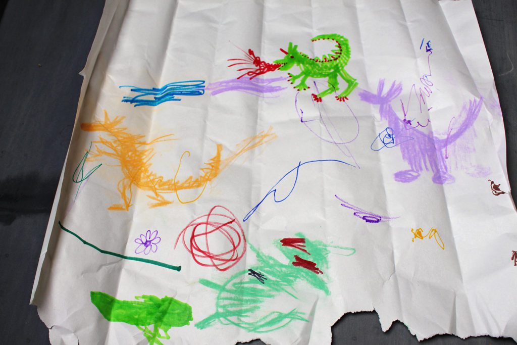 Scribble monsters colored on a coffee filter with markers. 