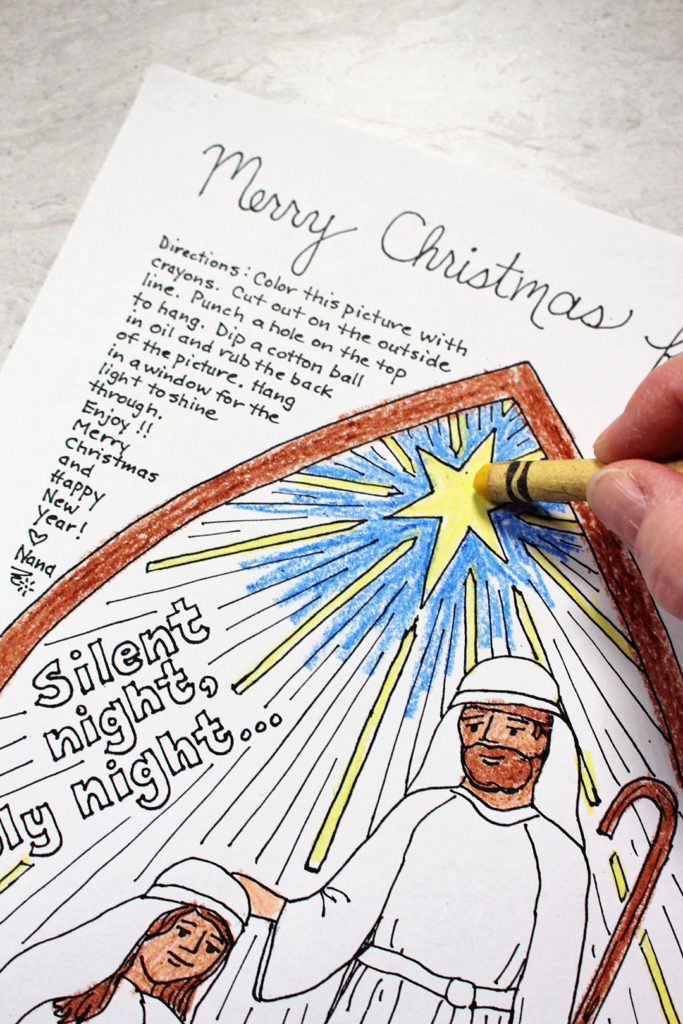 A yellow crayon coloring the star in a nativity scene. 