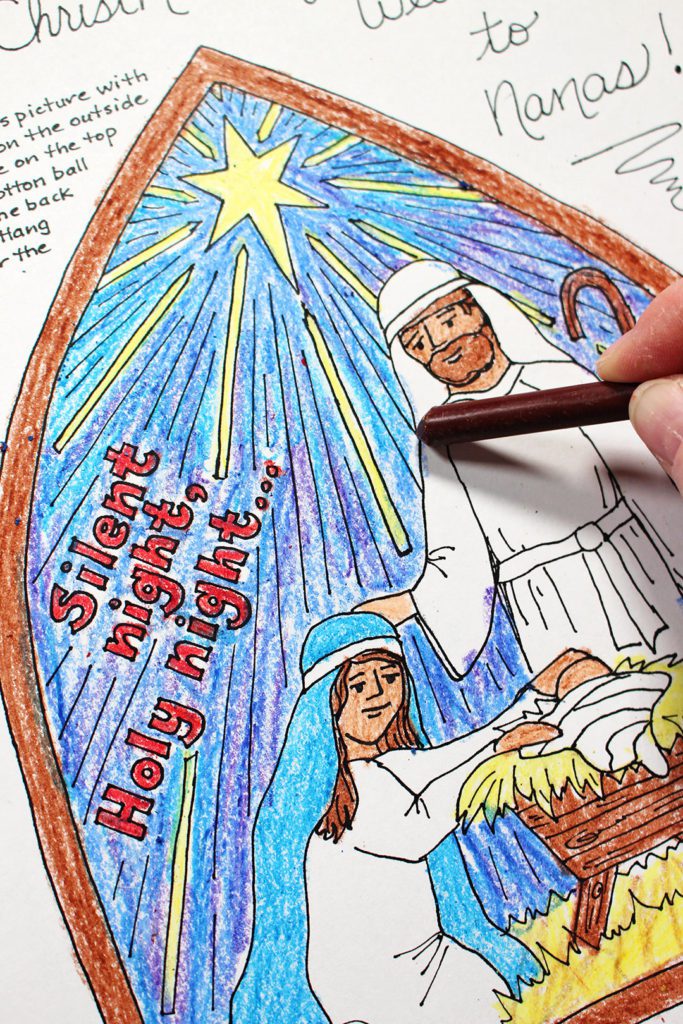 A brown crayon coloring Joseph in the manger scene. 