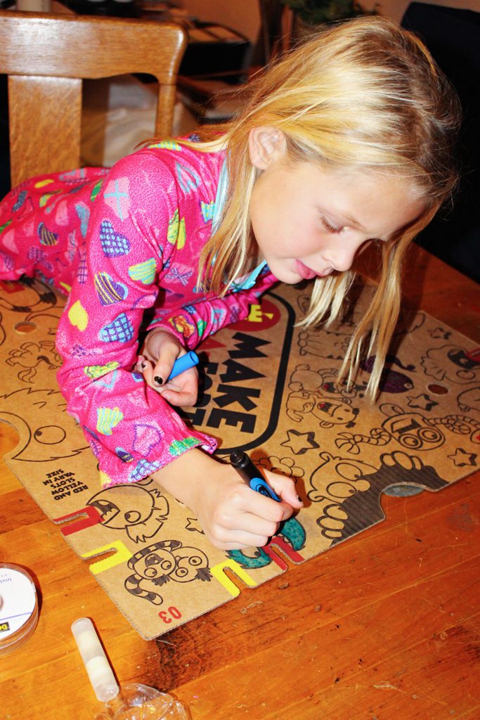 A child coloring the Make-a-Fort pieces