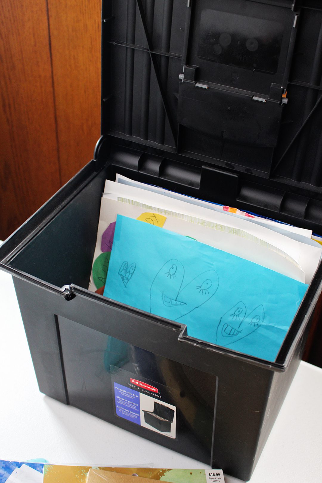 A filing box full of children's artwork.