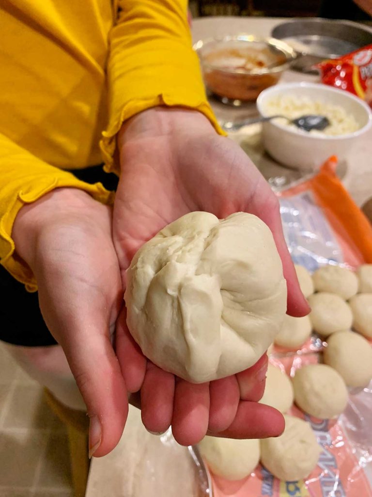 A child holding a ball of dough.