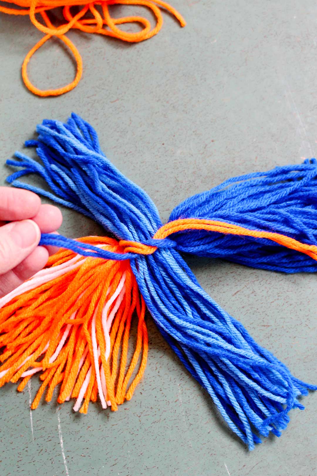 Blue and orange yarn tied in a bunch.