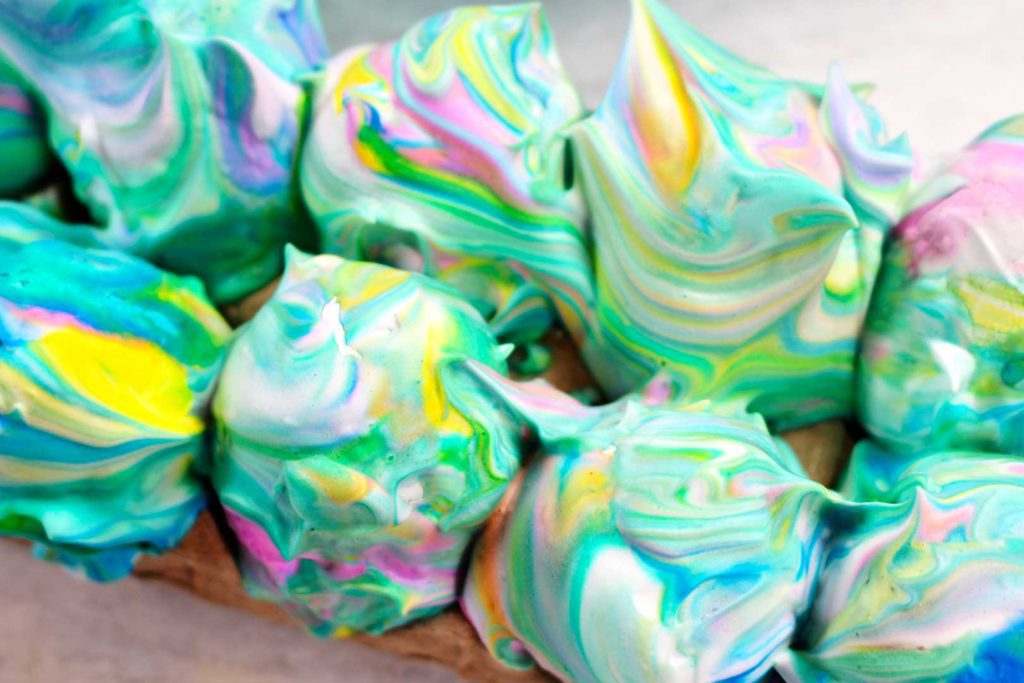 Eggs covered in yellow, green, blue, and pink swirled shaving cream.