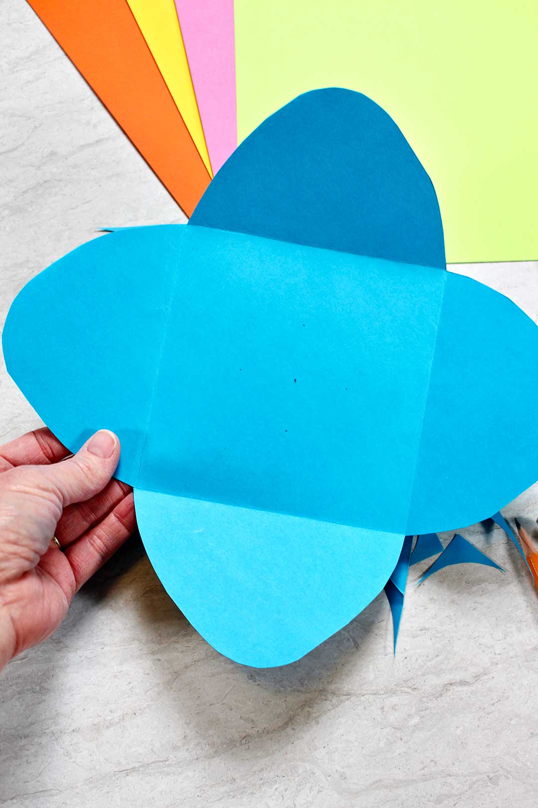 A blue homemade envelope cut from cardstock.