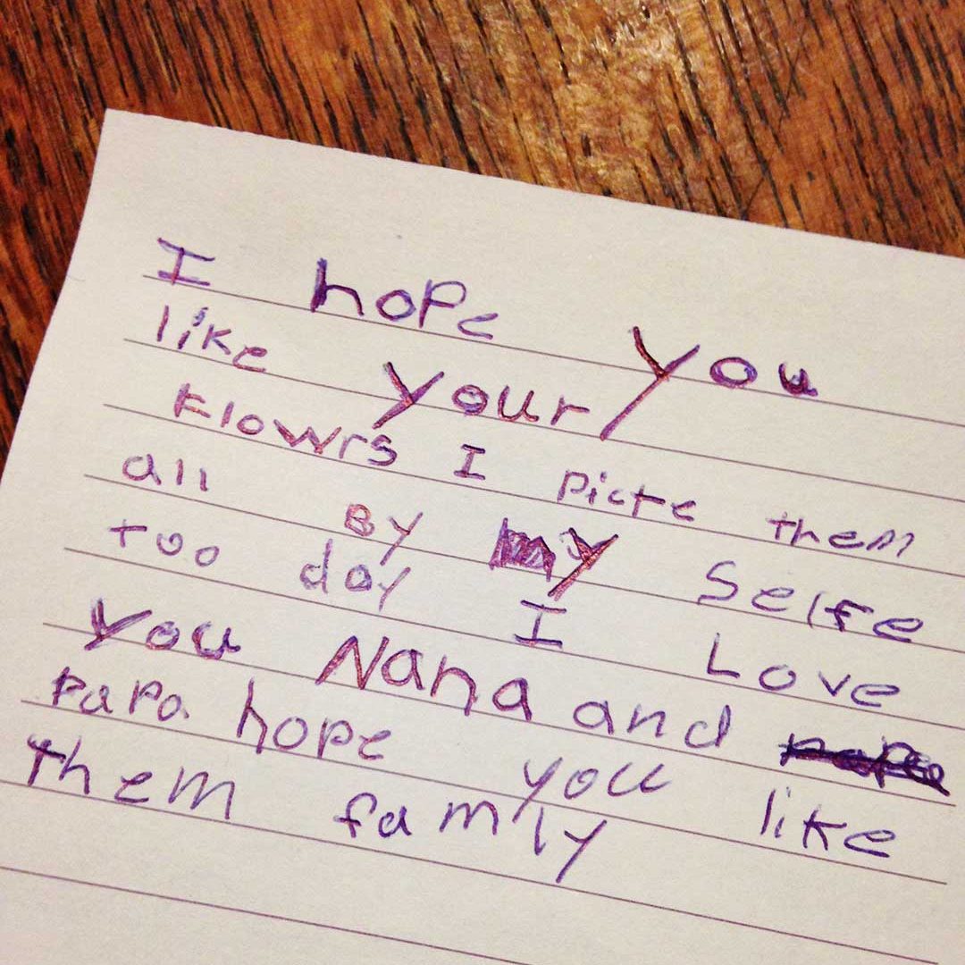 A note written by a child about Nana, picking flowers, and loving family.