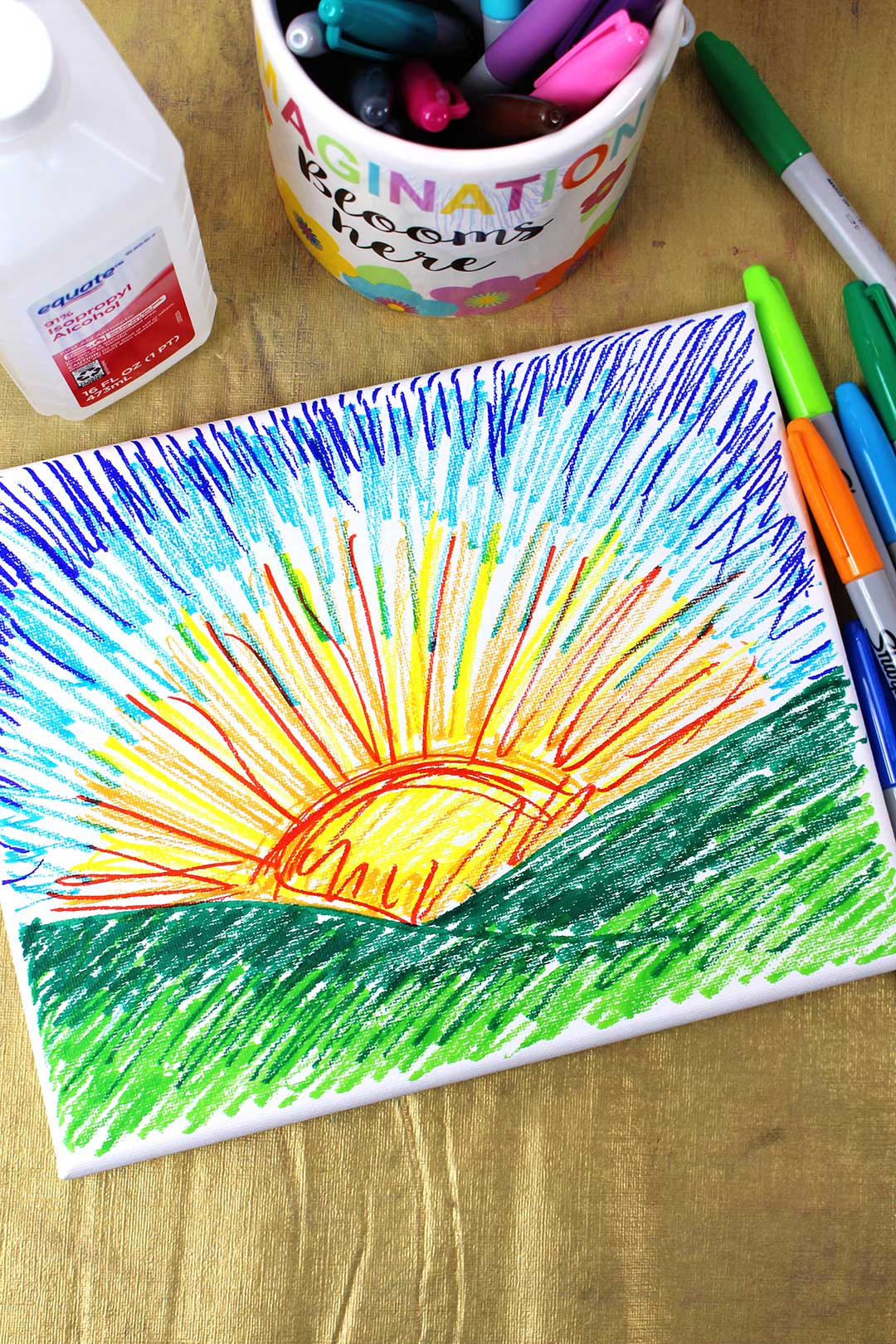 A sunset drawn with colorful sharpie markers on canvas.