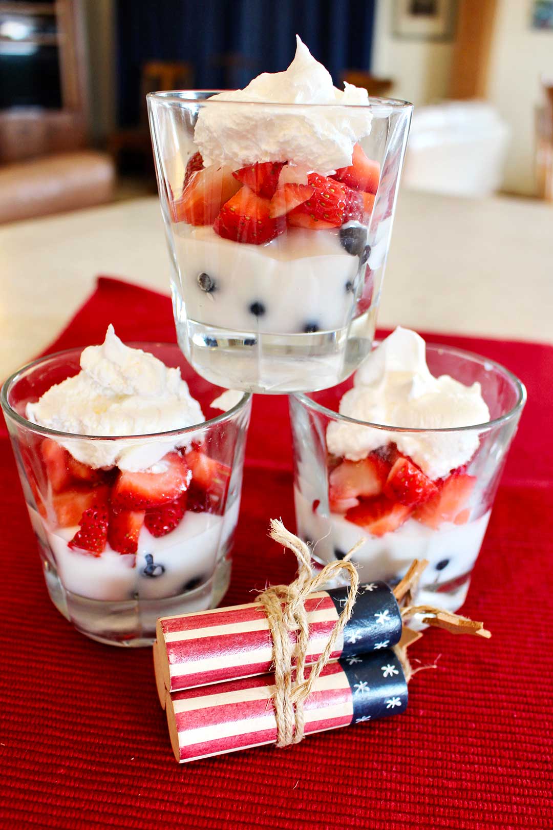 Red white and blue fruit parfaits with blueberries, strawberries, and whipped cream.