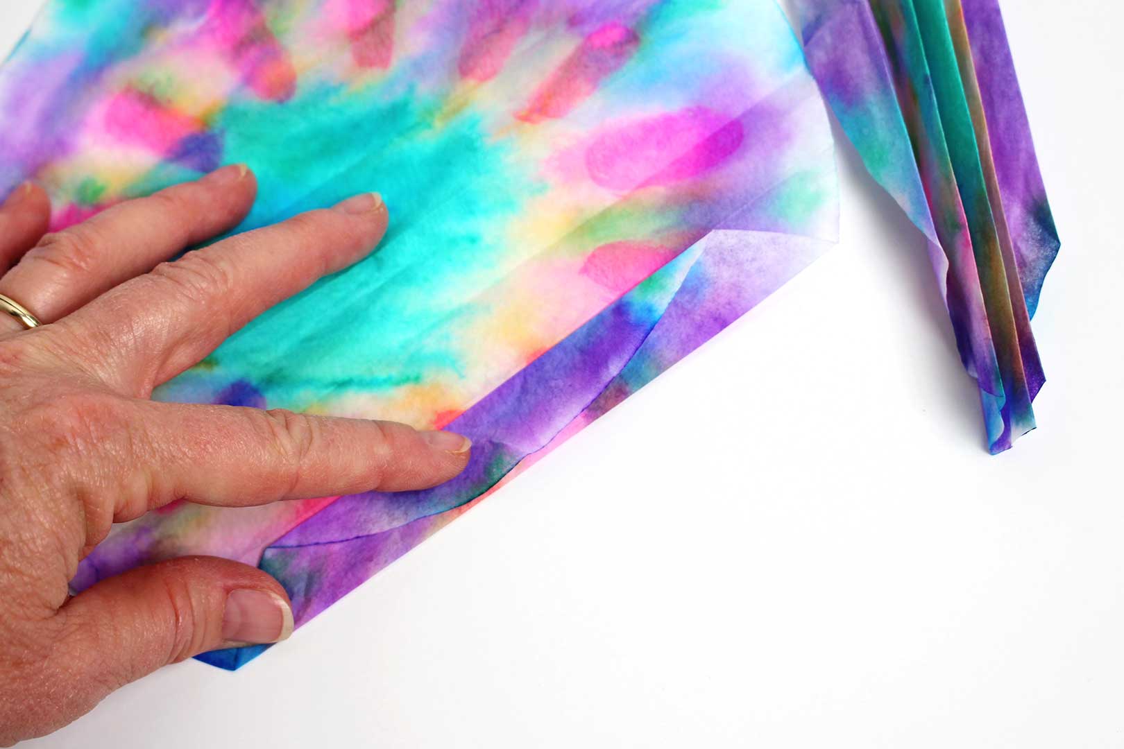 A colorful coffee filter folding back and forth like a fan.