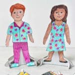 Boy and girl paper dolls, colored and dressed on their bases. Colored pencils and other colored clothing options nearby.