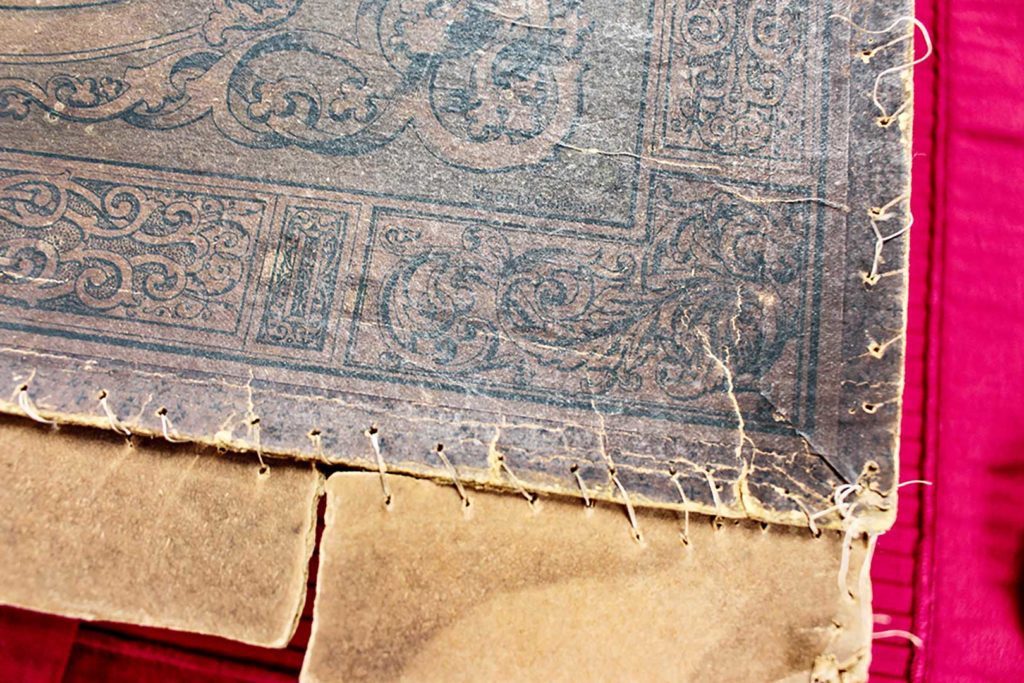 Detail stitching of antique tea set box.