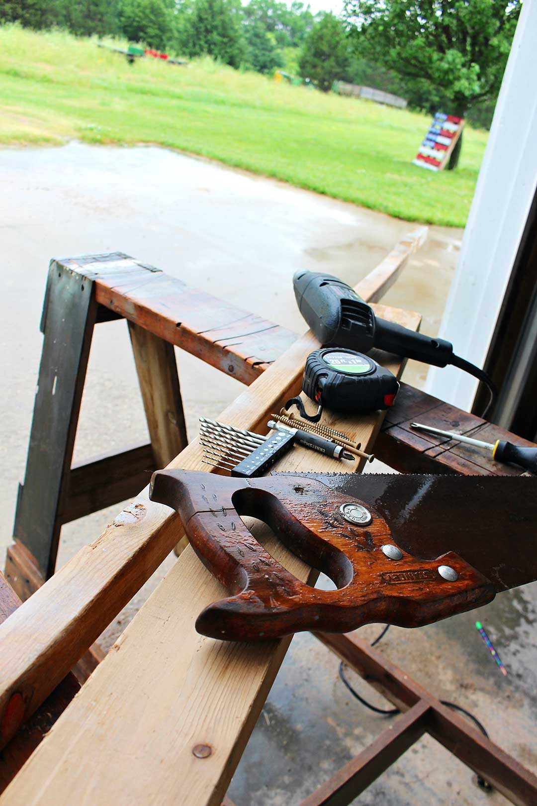 Woodworking supplies resting on a sawhorse.