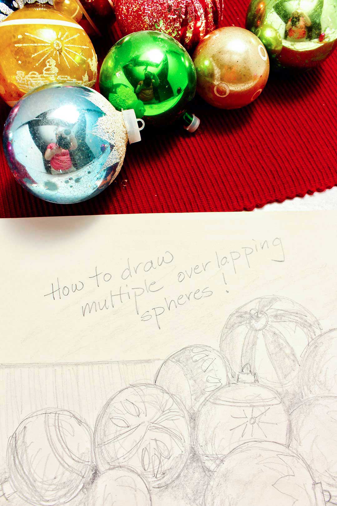 Close up view of finished Christmas ornament drawing with words "How to draw multiple overlapping spheres!" written on it.