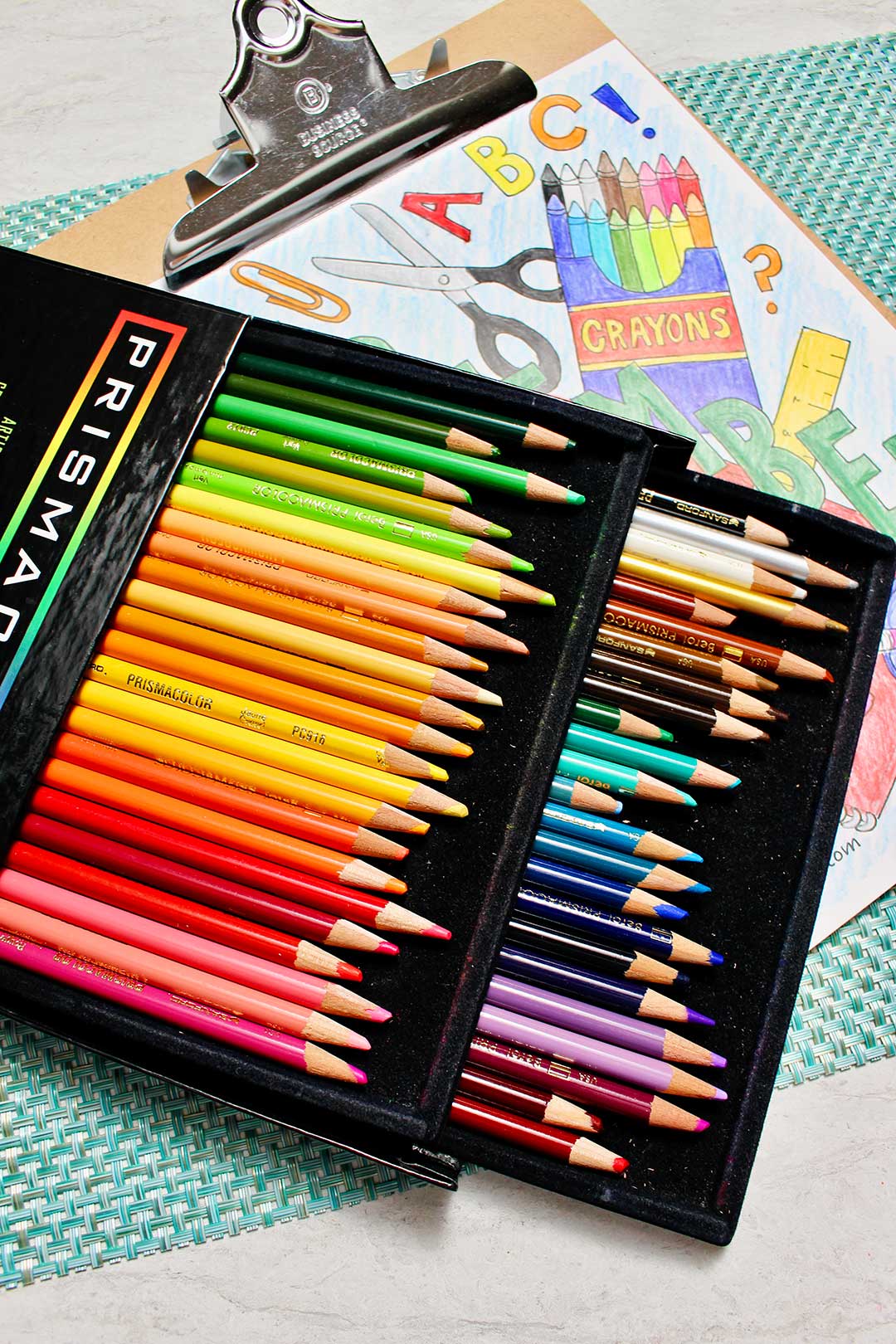 Colored pencils in rainbow order on top of a completed September coloring sheet.