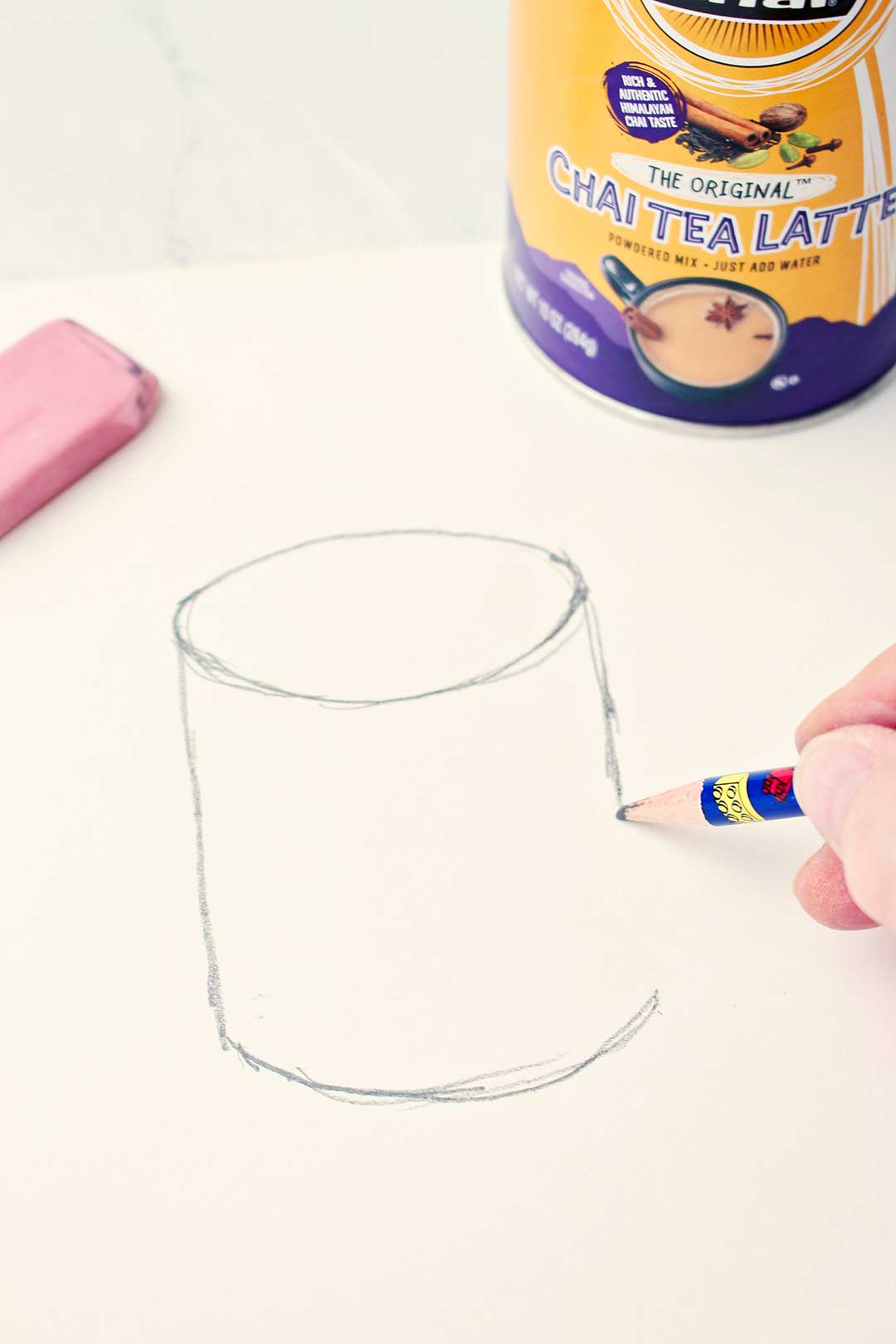 Rough drawing of a cylinder with chai tea latte container nearby.