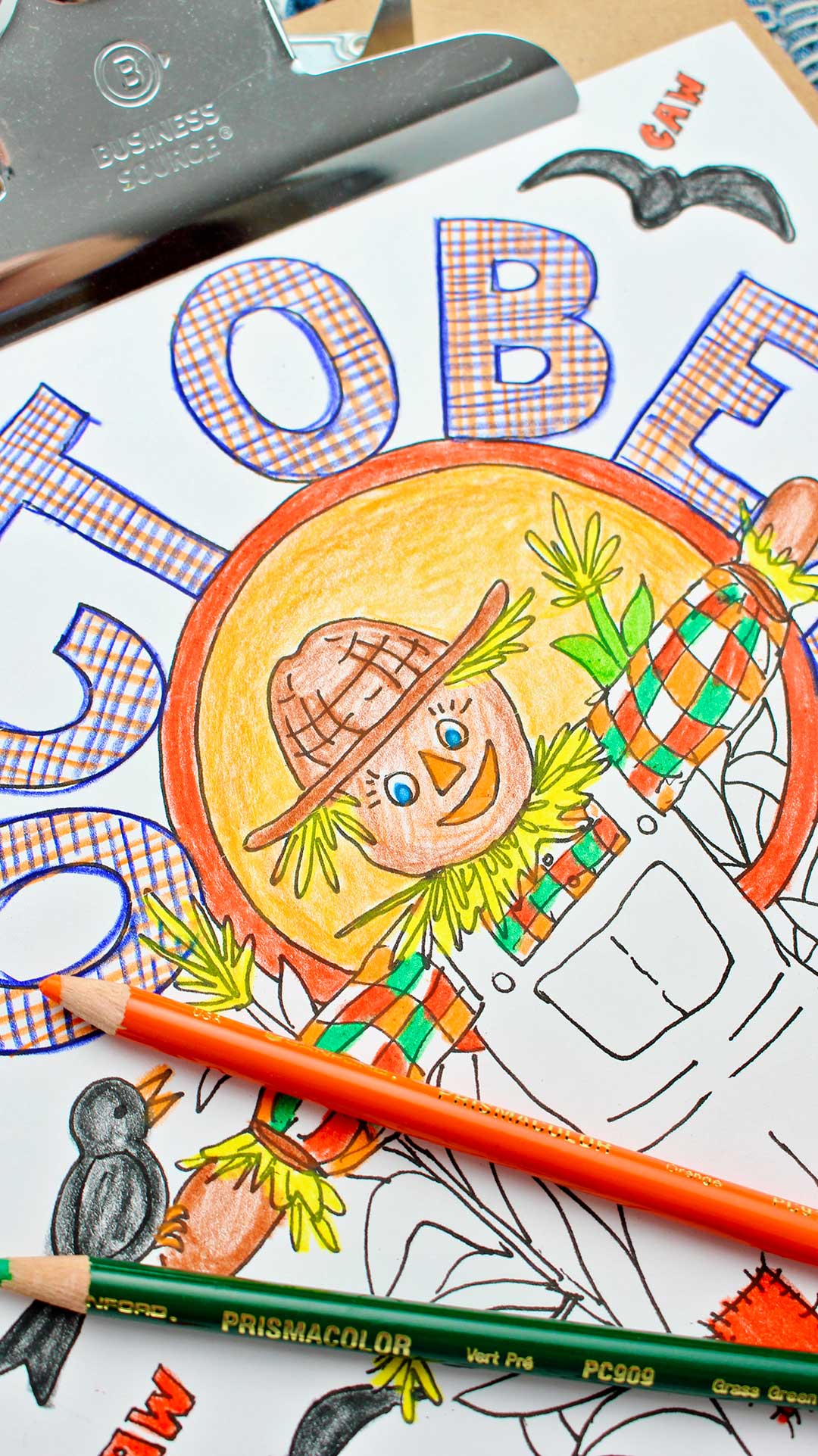 Half finished October coloring page with orange and green colored pencil resting on it.