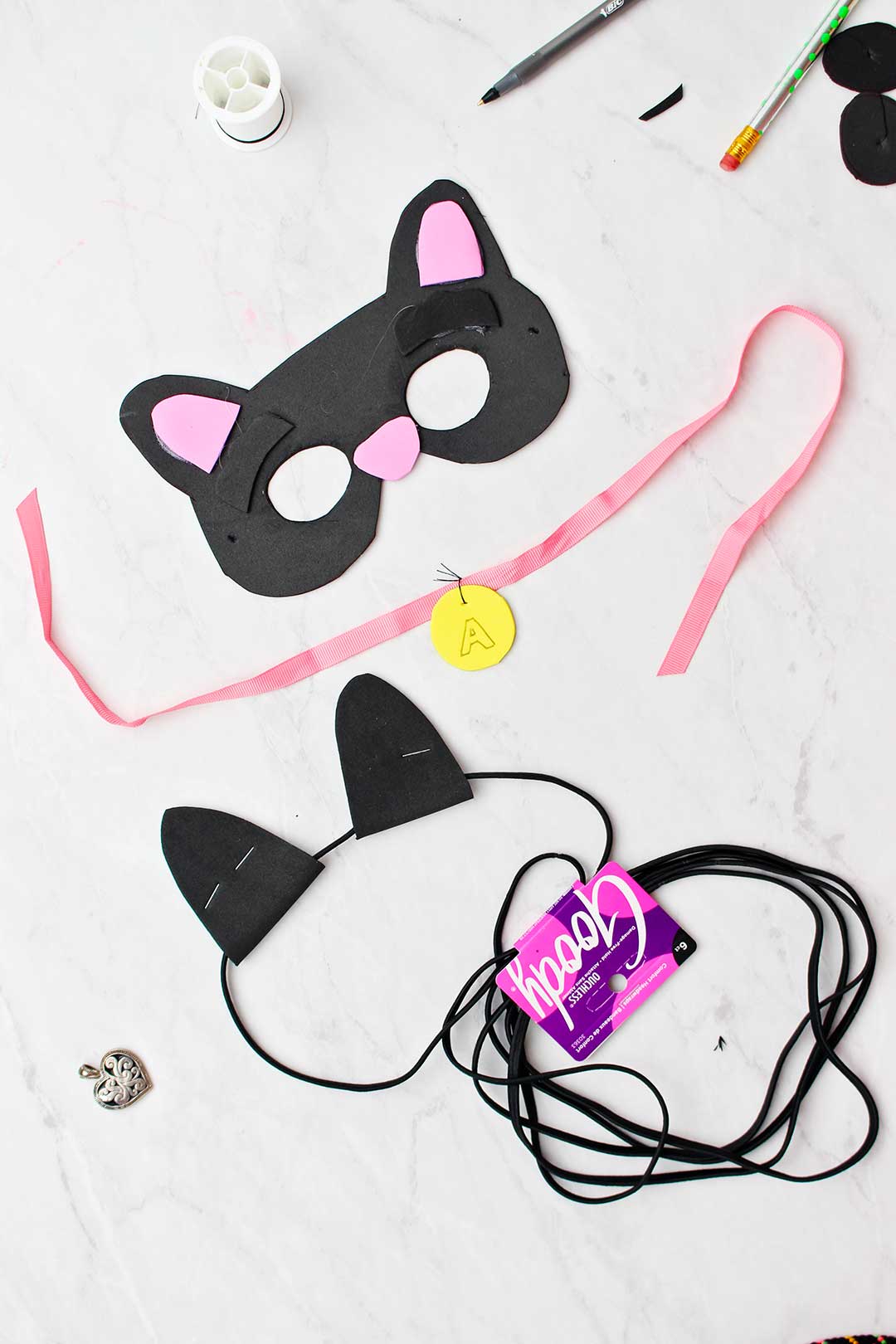 Black cat mask, collar and ears made from foam and black hair elastic.
