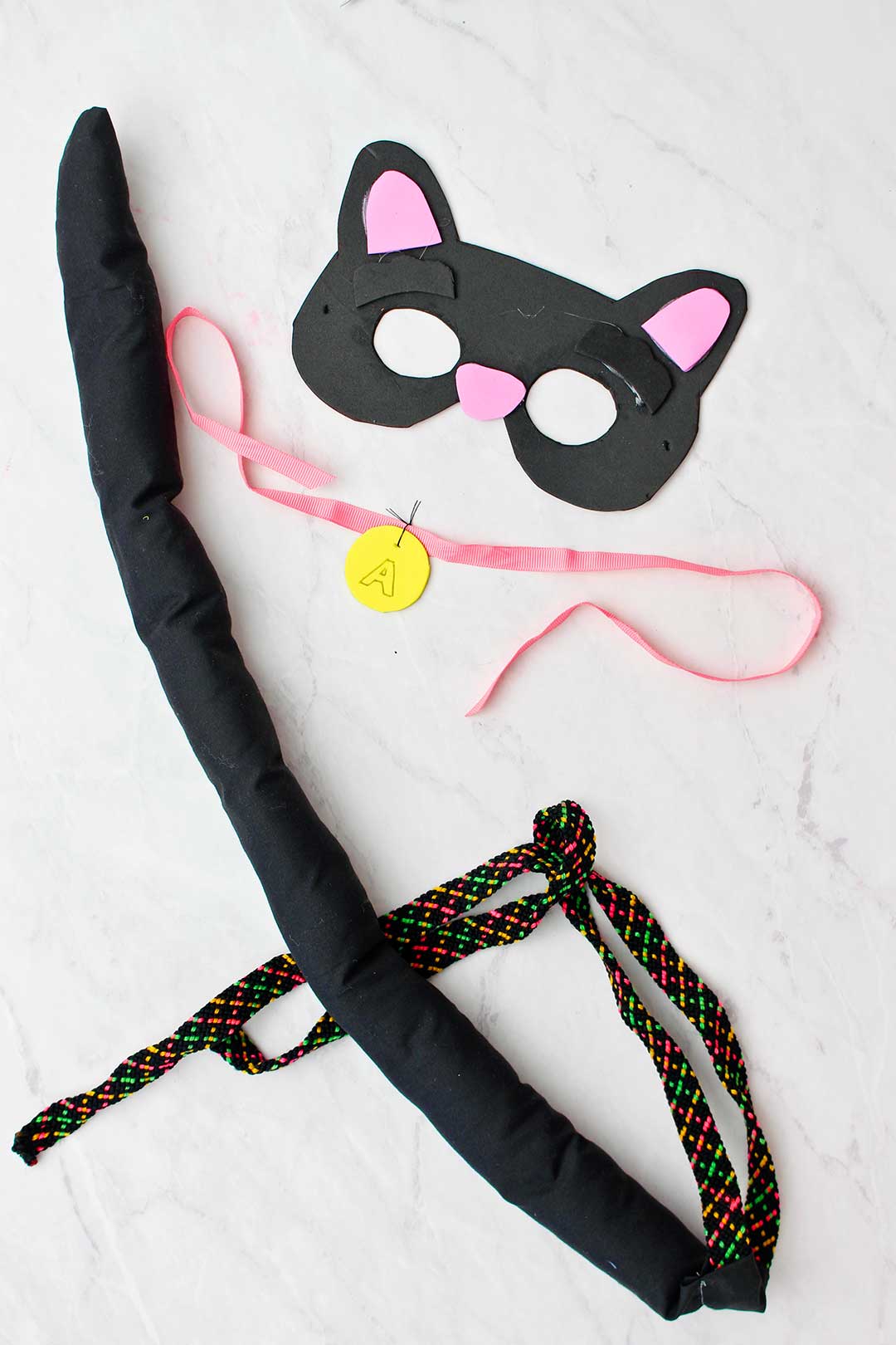 Black cat mask, collar and tail.