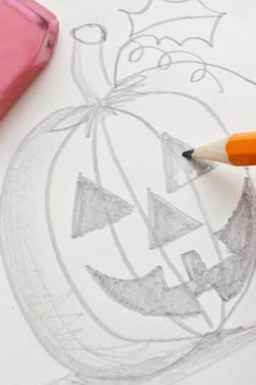 Pencil coloring in the eye of the jack-o-lantern pumpkin sketch.