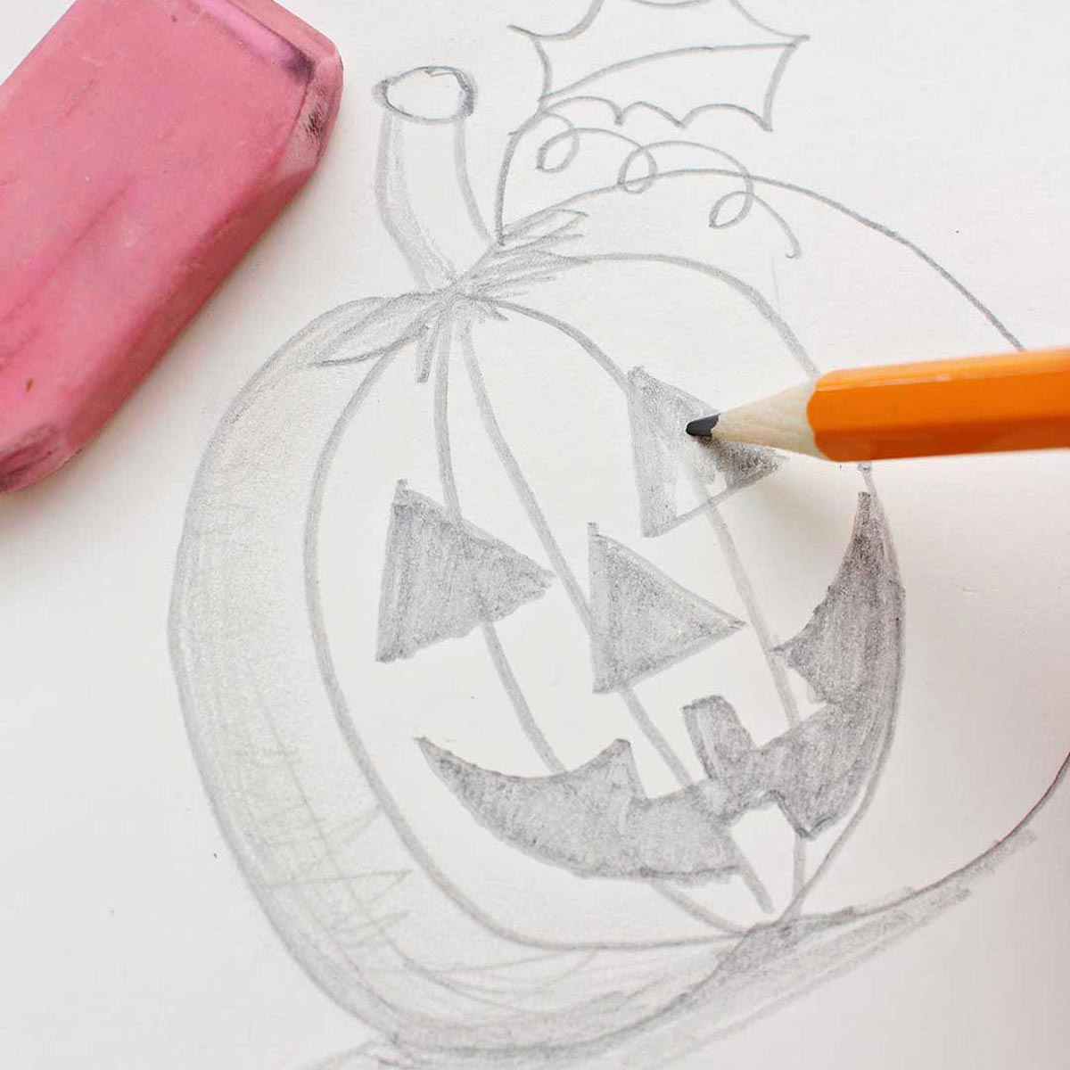 Pencil coloring in the eye of the jack-o-lantern pumpkin sketch.