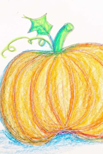 Colored pumpkin sketch greeting card resting on a blue woven placemat.