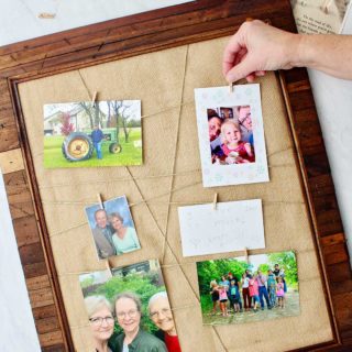 Hand clipping photo on Upcycled Picture Frame with supplies surrounding the final project.
