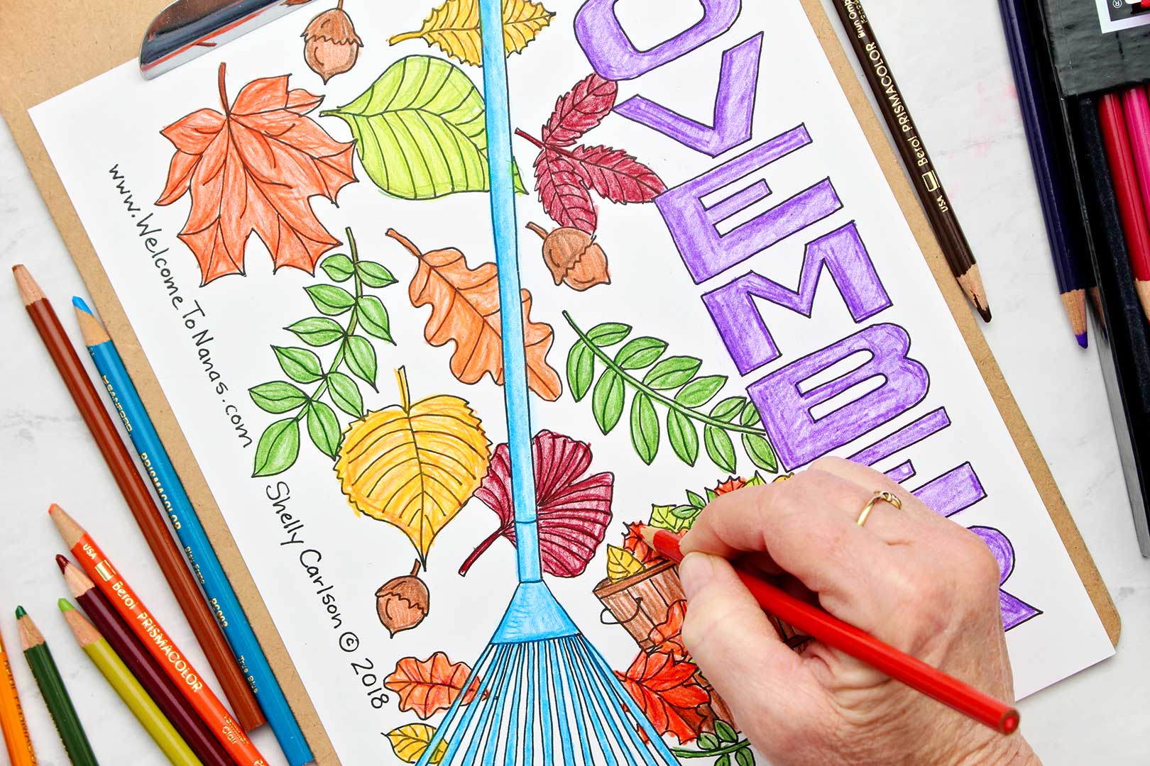 Hand coloring finishing touches on November coloring page.