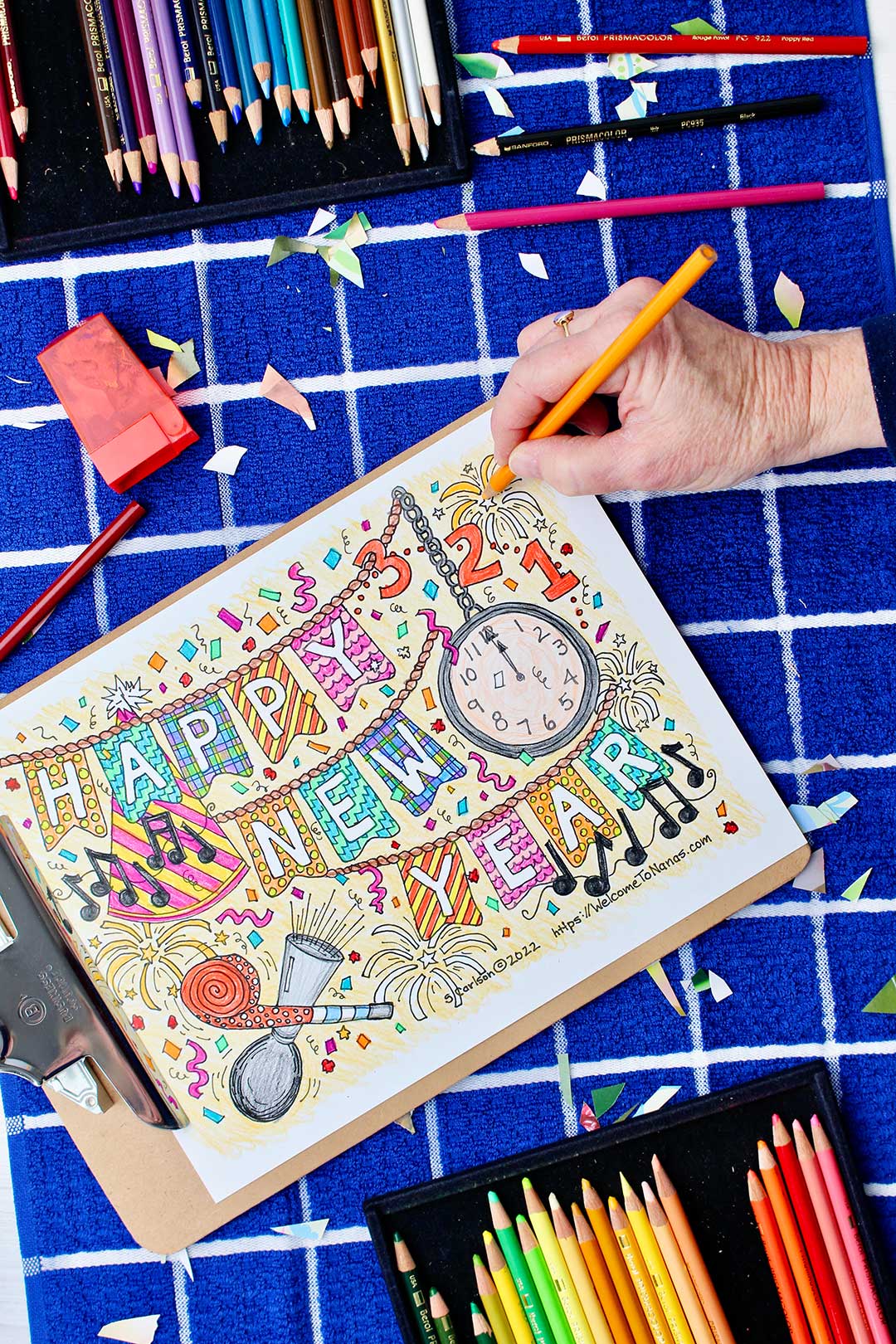 Hand coloring a firework yellow-orange on the New Year's Coloring Page.