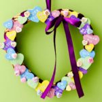 Completed Conversation Heart Wreath hung against a celery green backdrop.