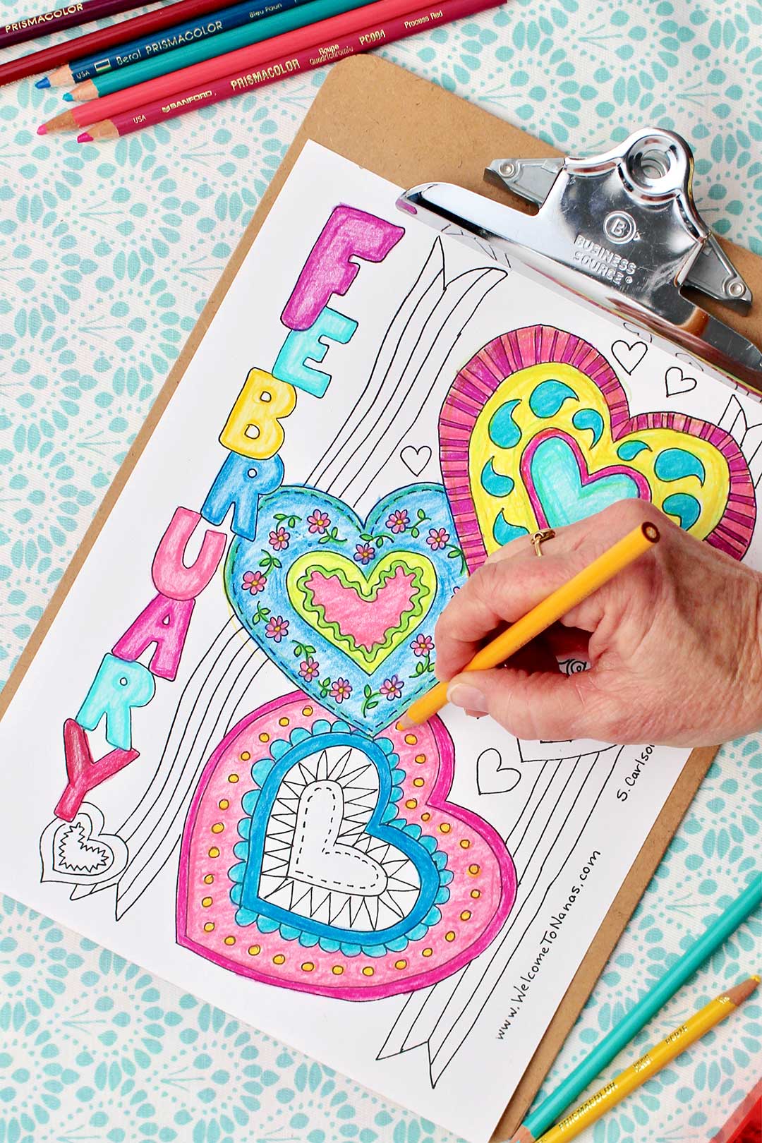 Hand coloring yellow dots on heart on February coloring page.