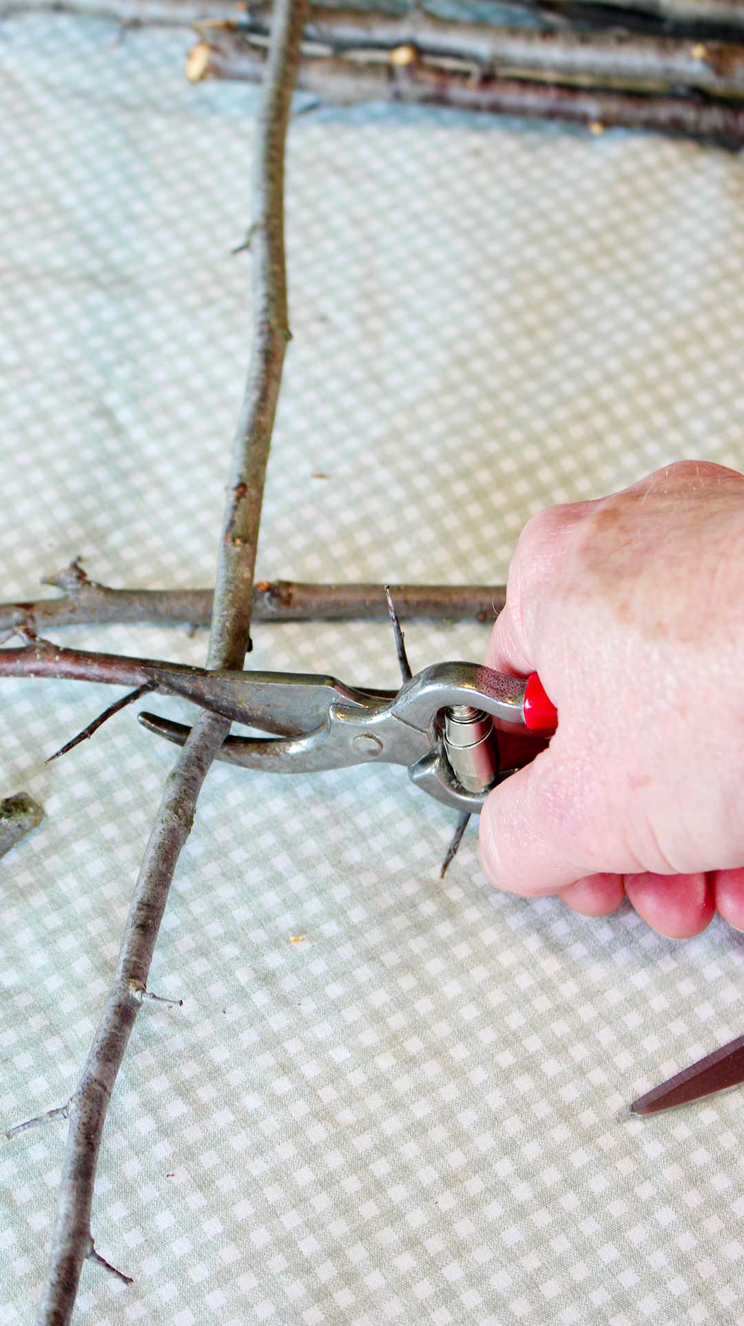 Hand clipping twigs to desired size.