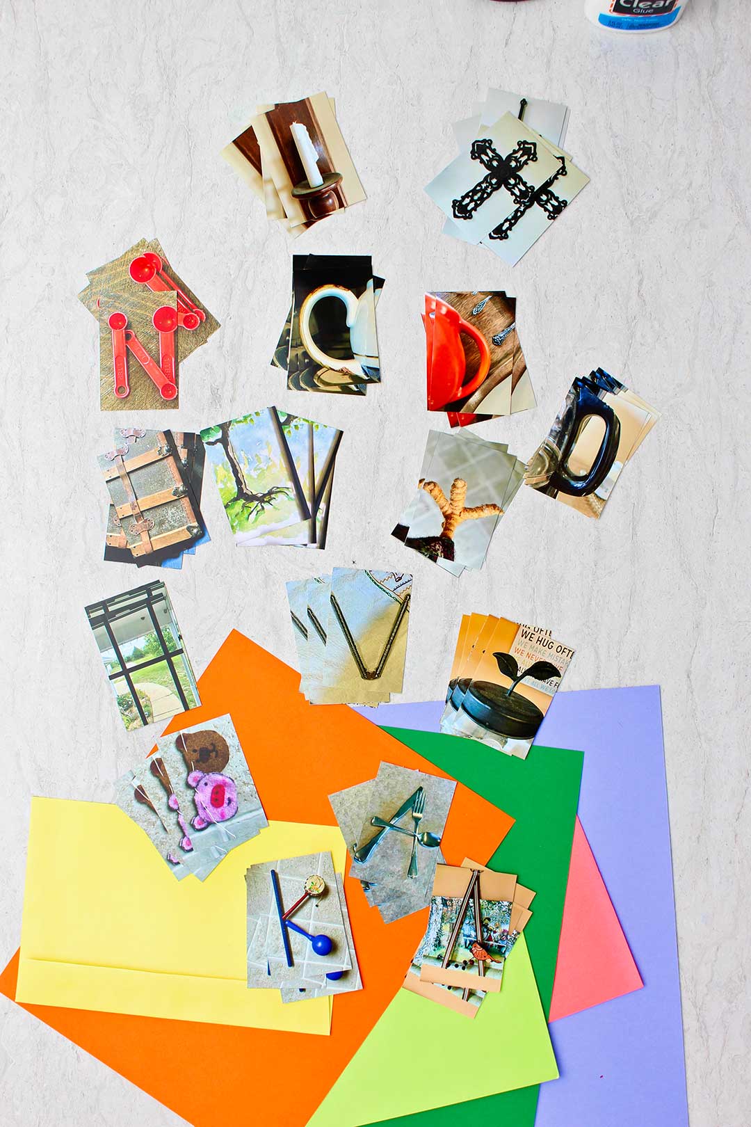 Stacks of printed photo letters and colorful pieces of paper.