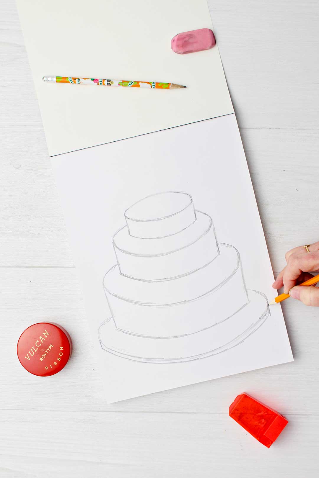 Hand sketching final bottom tier of wedding cake.