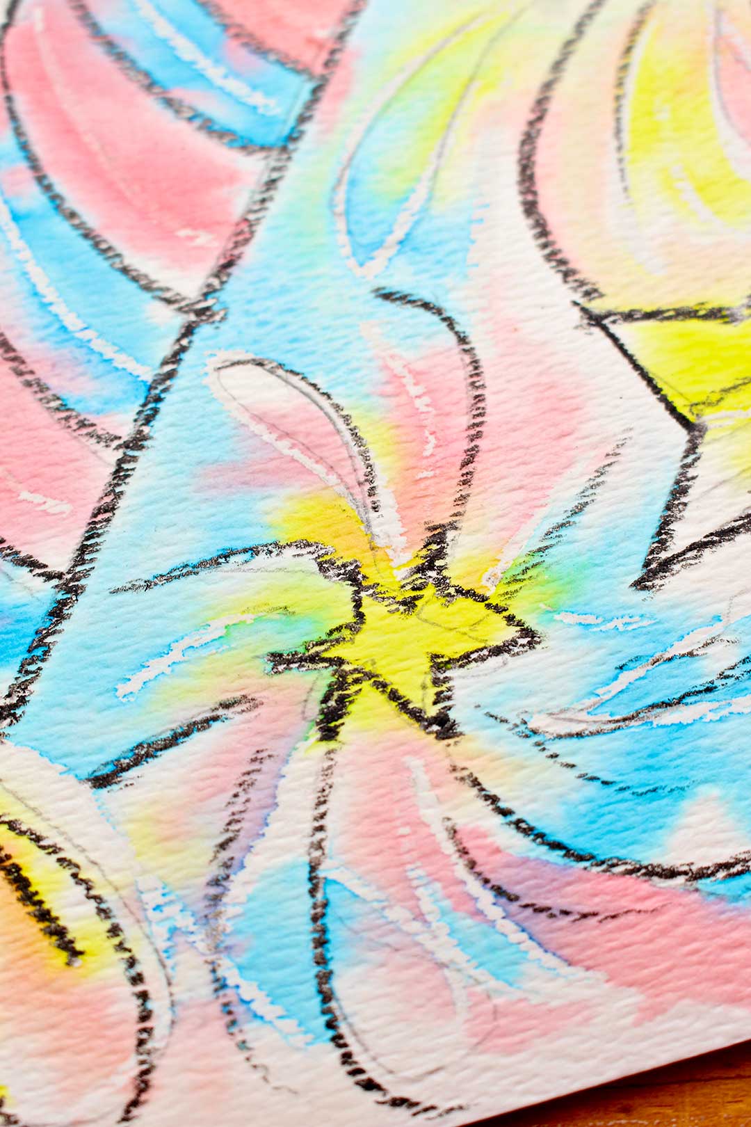 Full frame close up of a star on the watercolor resist with crayon painting.