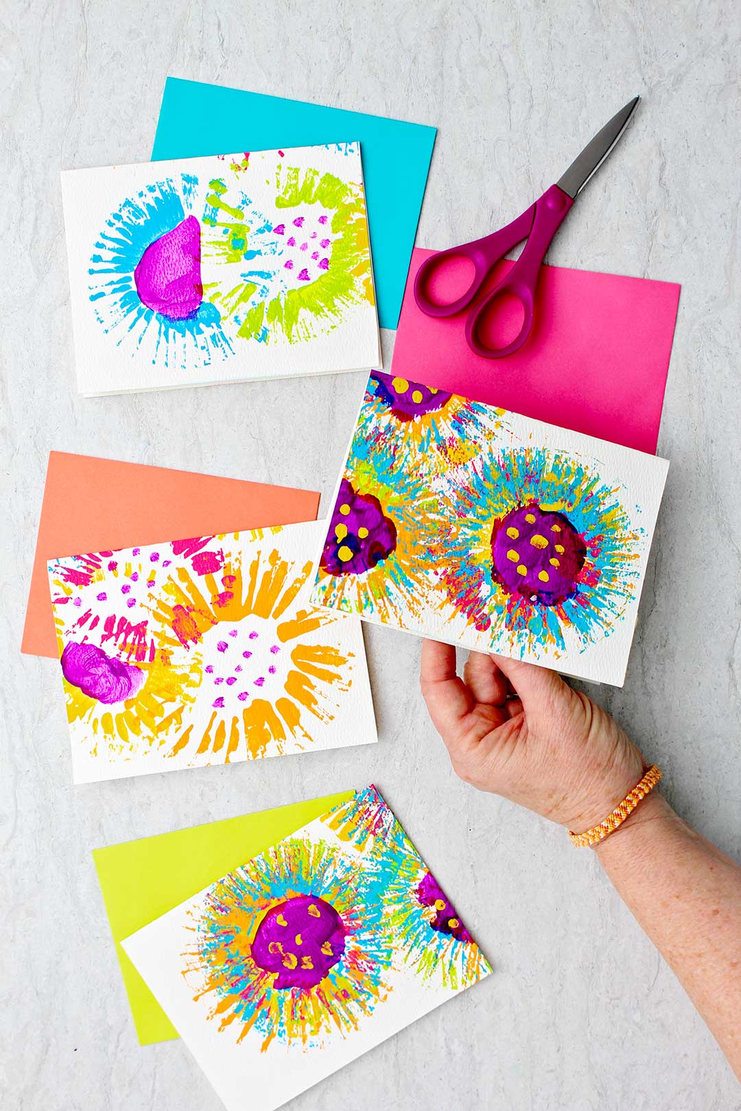 Cards and colorful envelopes with flower paintings on them.